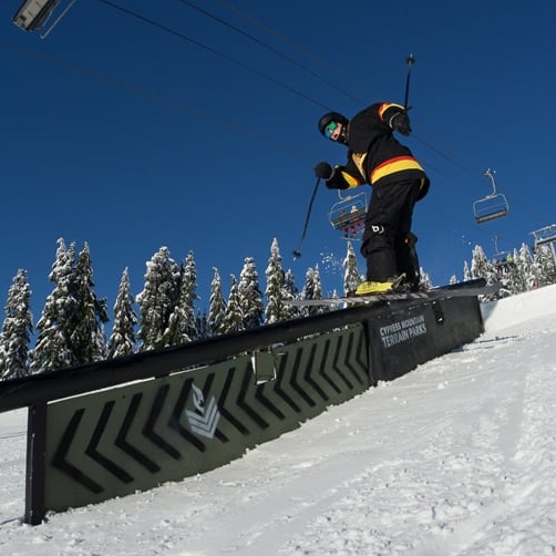 Skier riding rail in terrain park